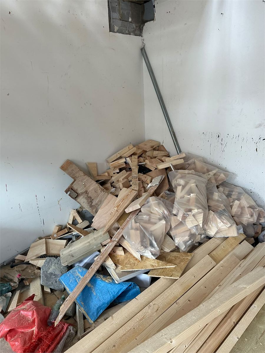 Timber offcuts and bagged construction waste ready for collection